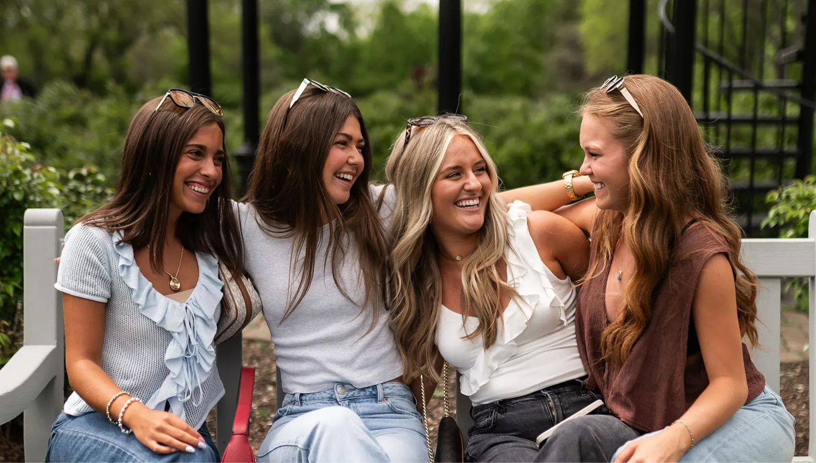 Girls sitting on a bench laughing
